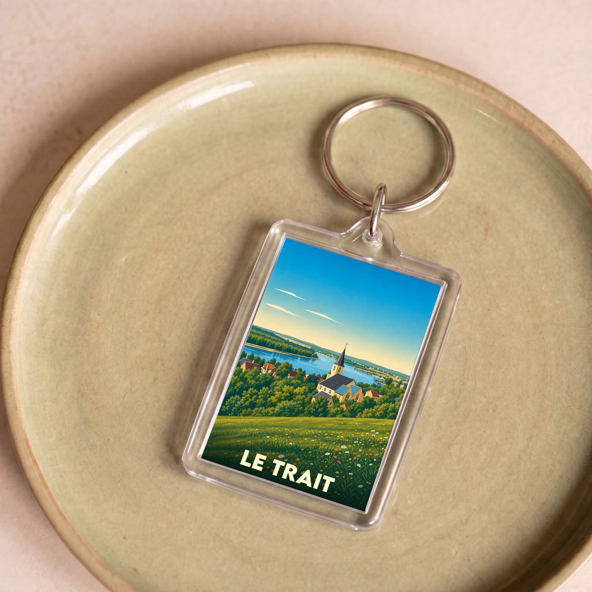 Porte-clés souvenir de la ville de Le Trait avec une illustration stylisée.