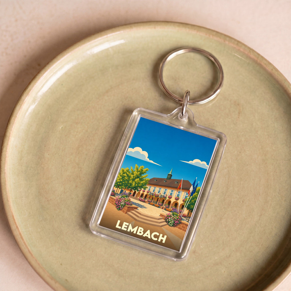 Porte-clés souvenir de la ville de Lembach avec une illustration stylisée.