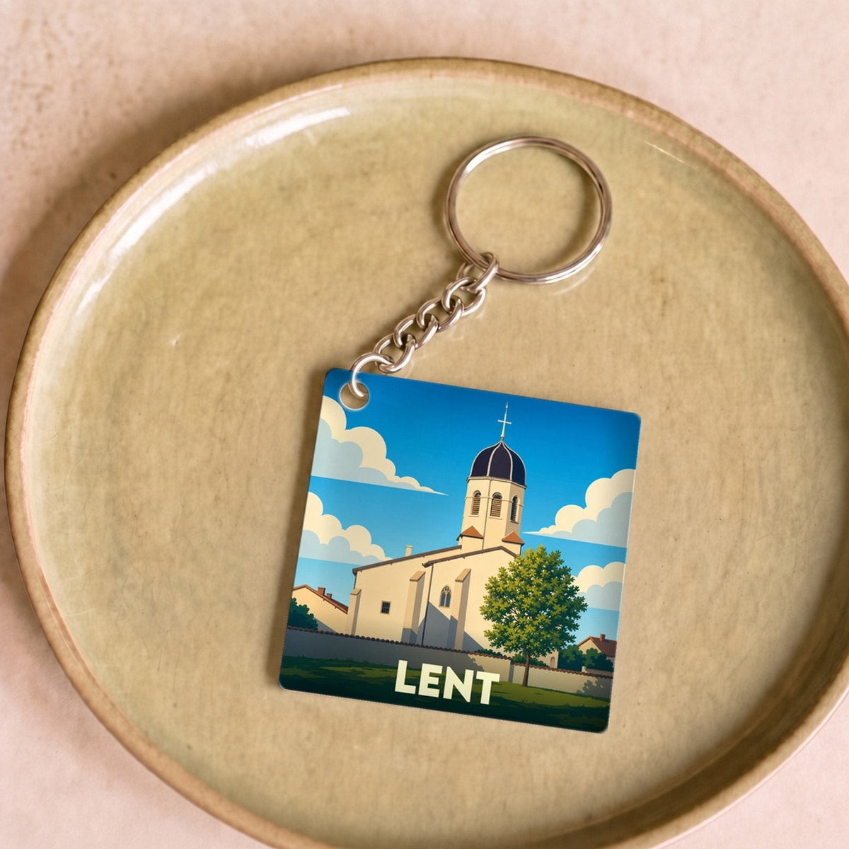 Porte-clés souvenir de la ville de Lent avec une illustration stylisée de son église.