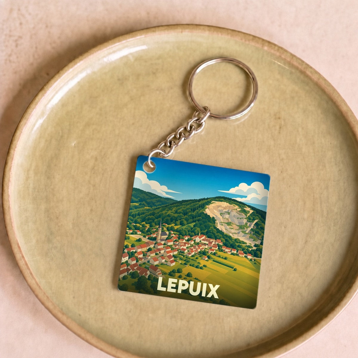 Porte-clés souvenir de la ville de Lepuix avec une illustration stylisée.