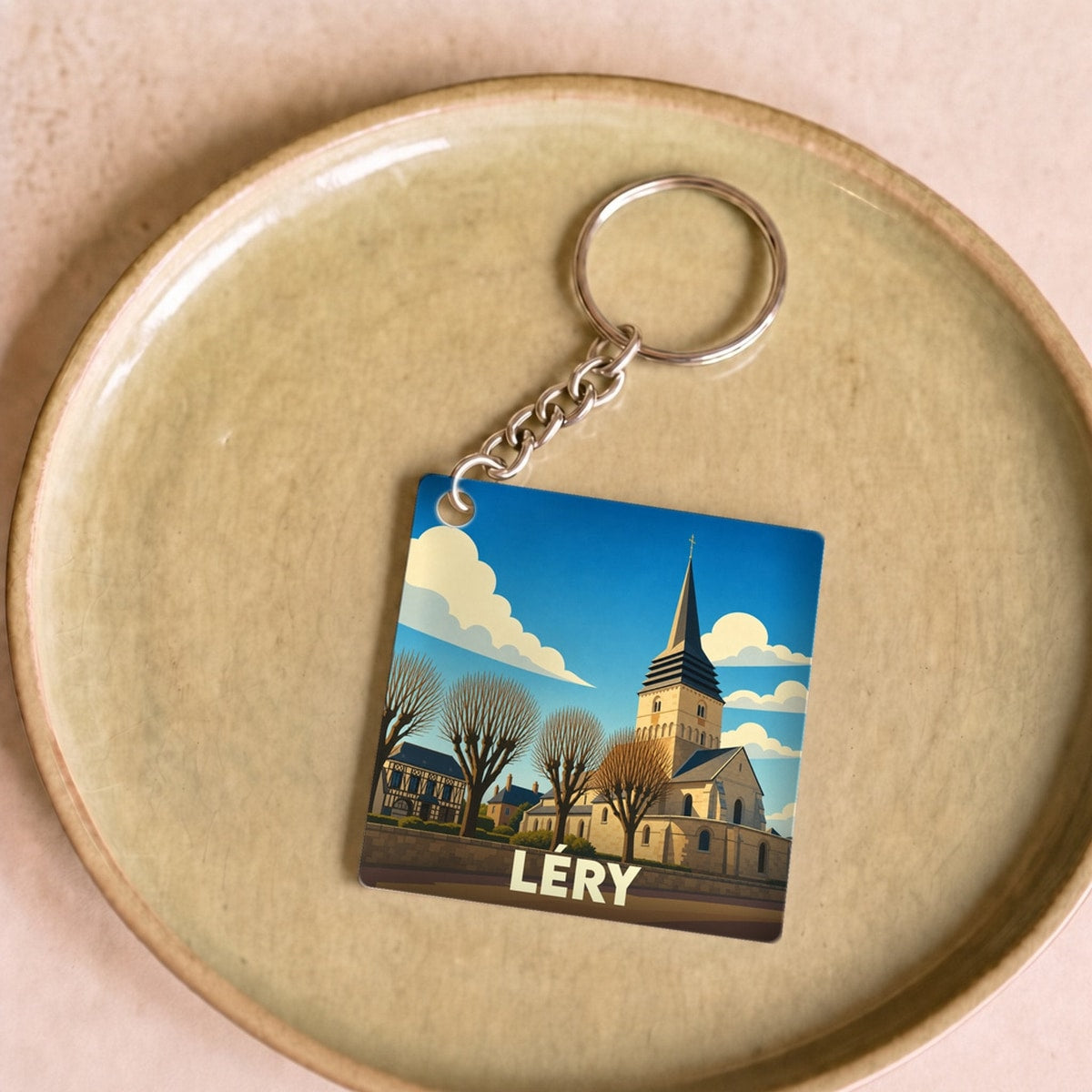 Porte-clés souvenir de la ville de Léry avec une illustration stylisée de son église.