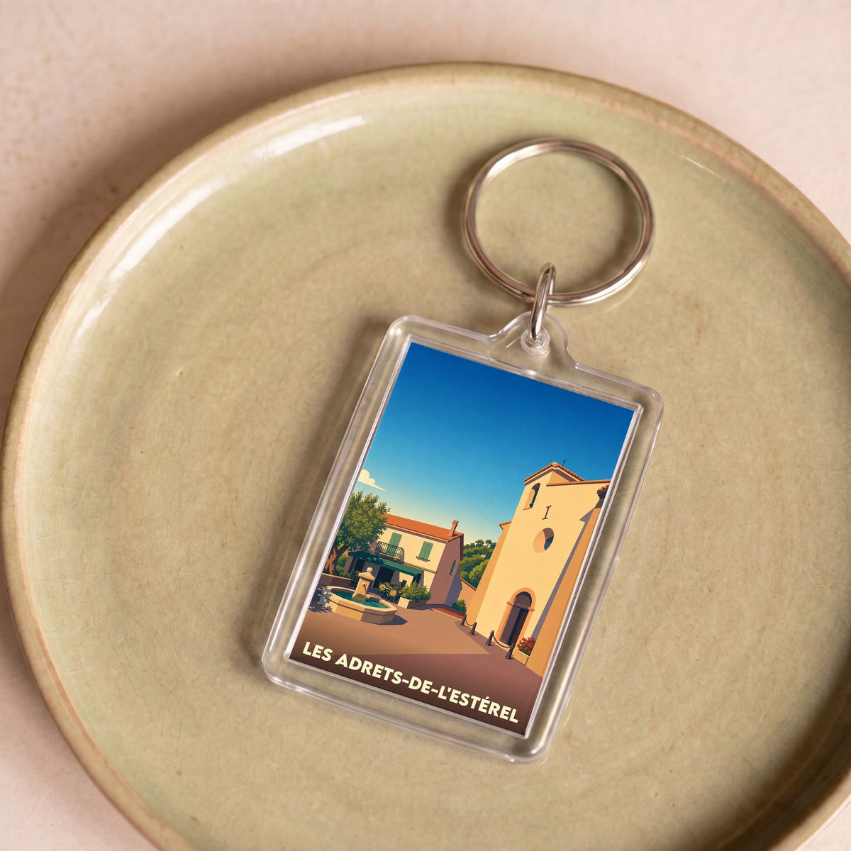 Porte-clés souvenir de la ville de Les Adrets-de-l'Estérel avec une illustration stylisée.