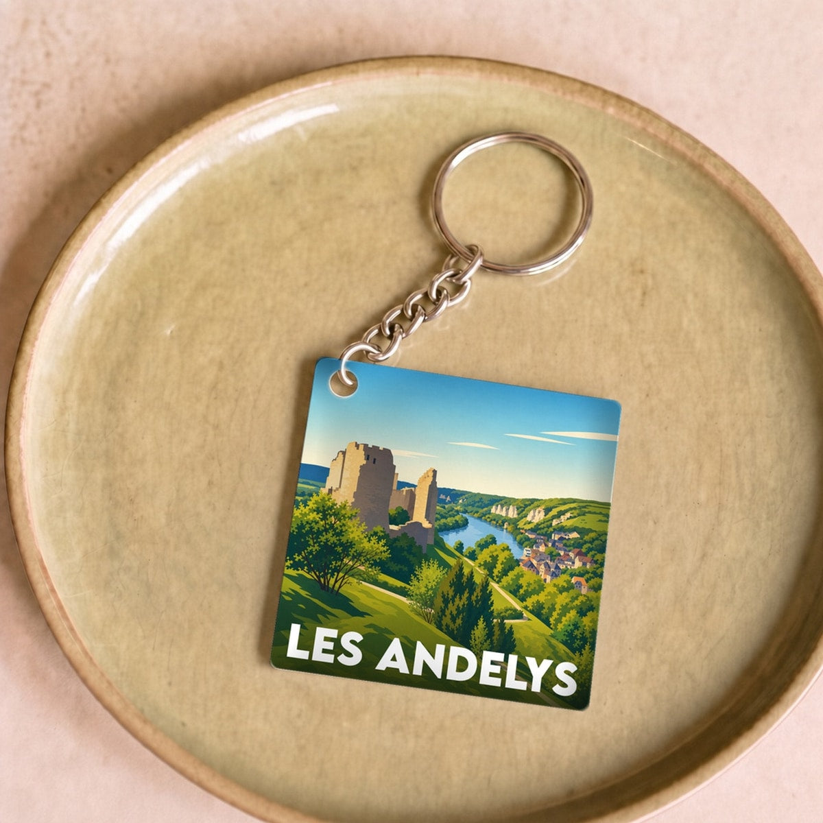 Porte-clés souvenir de la ville de Les Andelys avec une illustration stylisée.