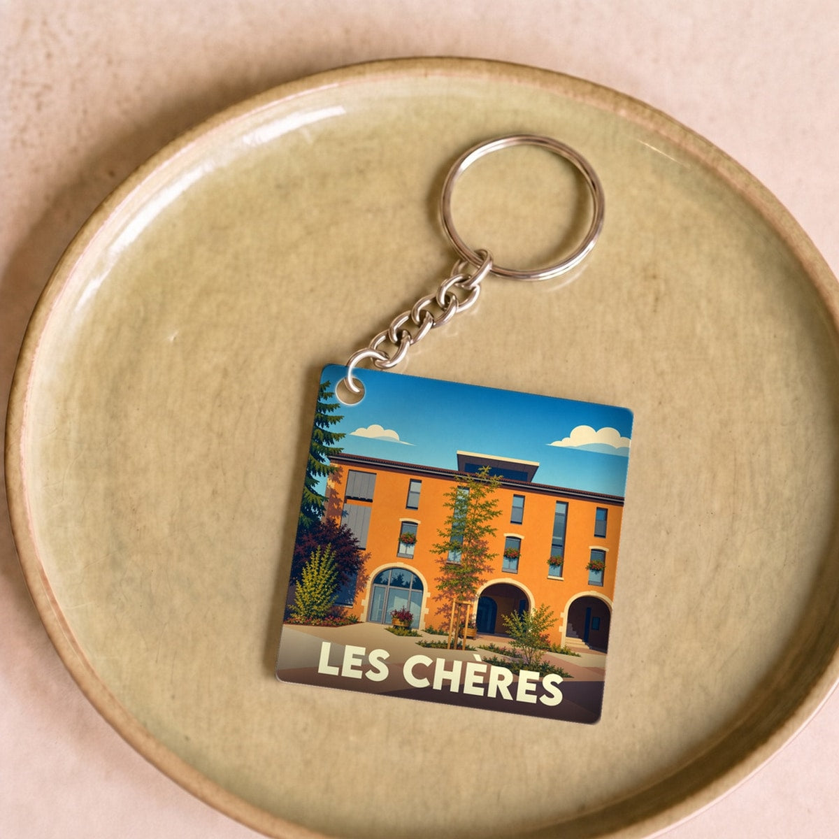 Porte-clés souvenir de la ville de Les Chères avec une illustration stylisée.
