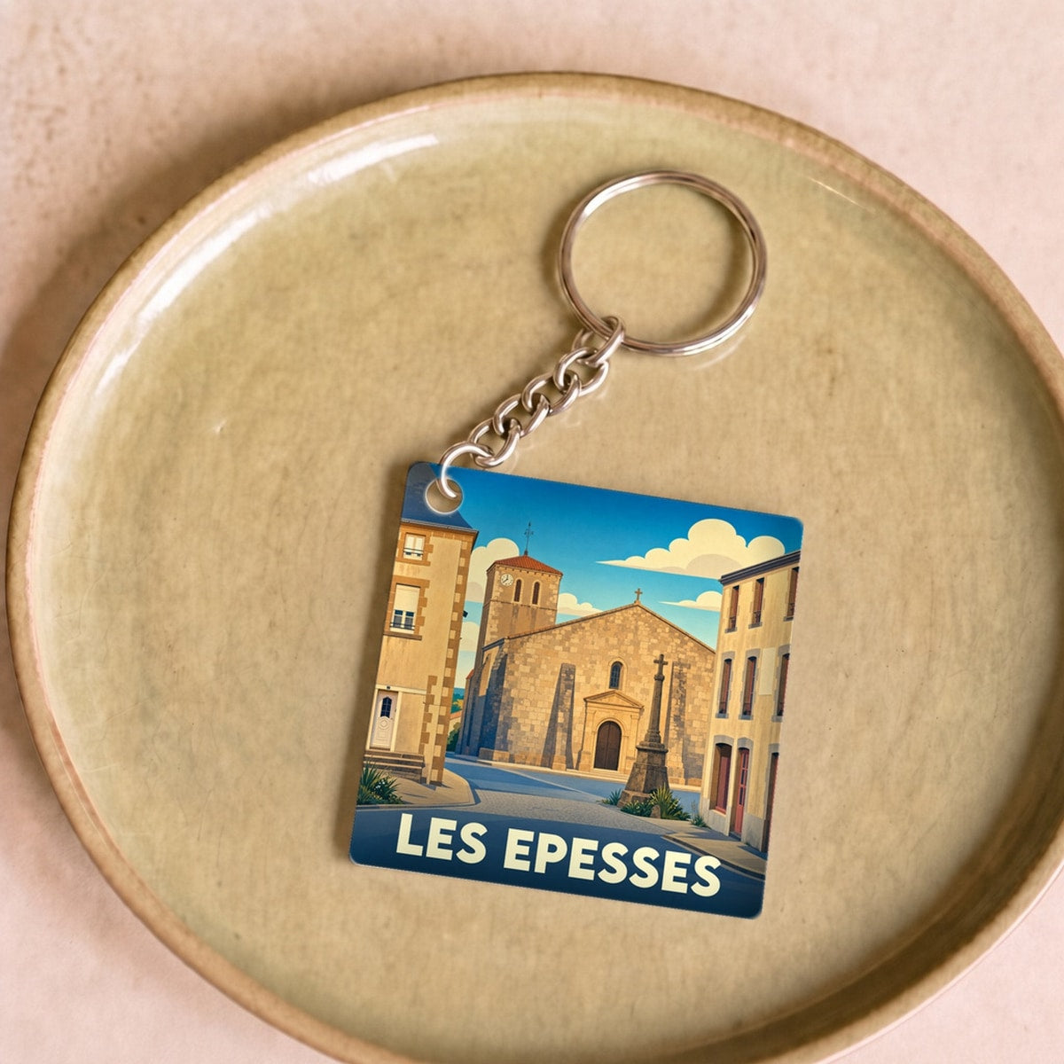Porte-clés souvenir de la ville de Les Epesses avec une illustration stylisée.