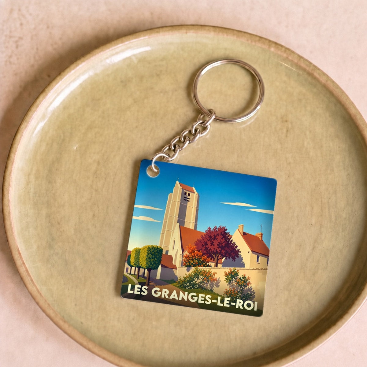 Porte-clés souvenir de la ville de Les Granges-le-Roi avec une illustration stylisée.