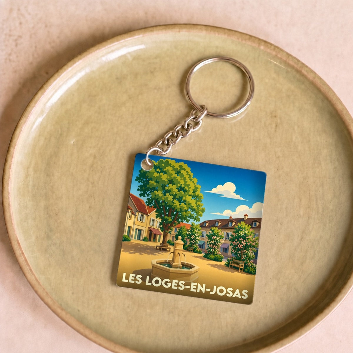 Porte-clés souvenir de la ville de Les Loges-en-Josas avec une illustration stylisée.