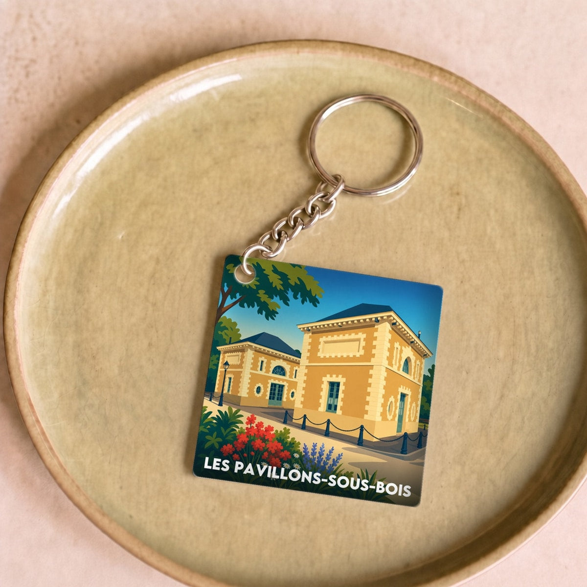 Porte-clés souvenir de la ville de Les Pavillons-sous-Bois avec une illustration stylisée.