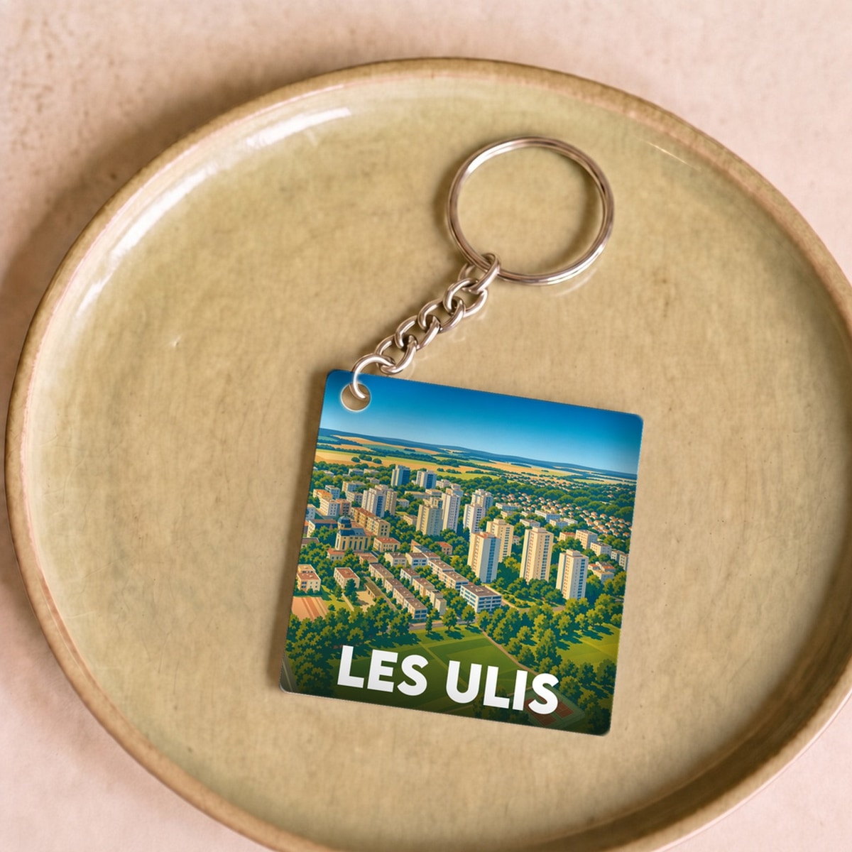 Porte-clés souvenir de la ville de Les Ulis avec une illustration aérienne colorée.