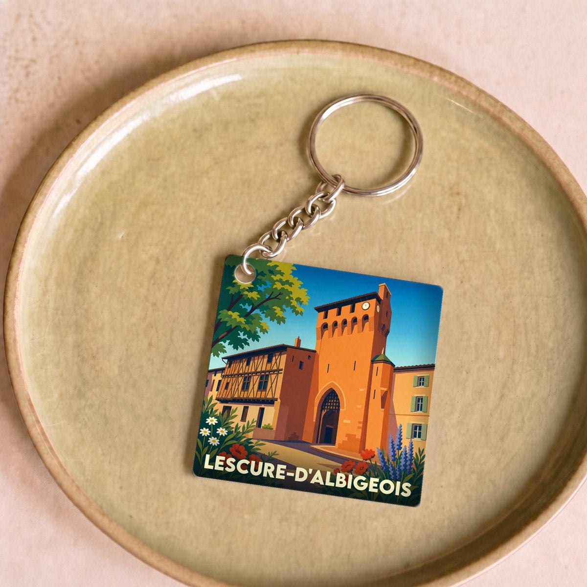Porte-clés souvenir de la ville de Lescure-d'Albigeois avec une illustration stylisée de son patrimoine.