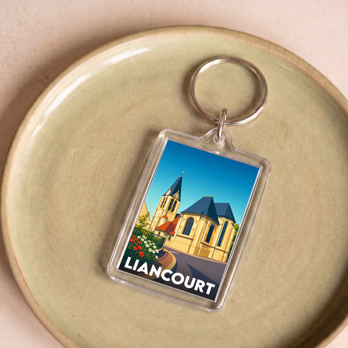 Porte-clés souvenir de la ville de Liancourt avec une illustration stylisée de son église.