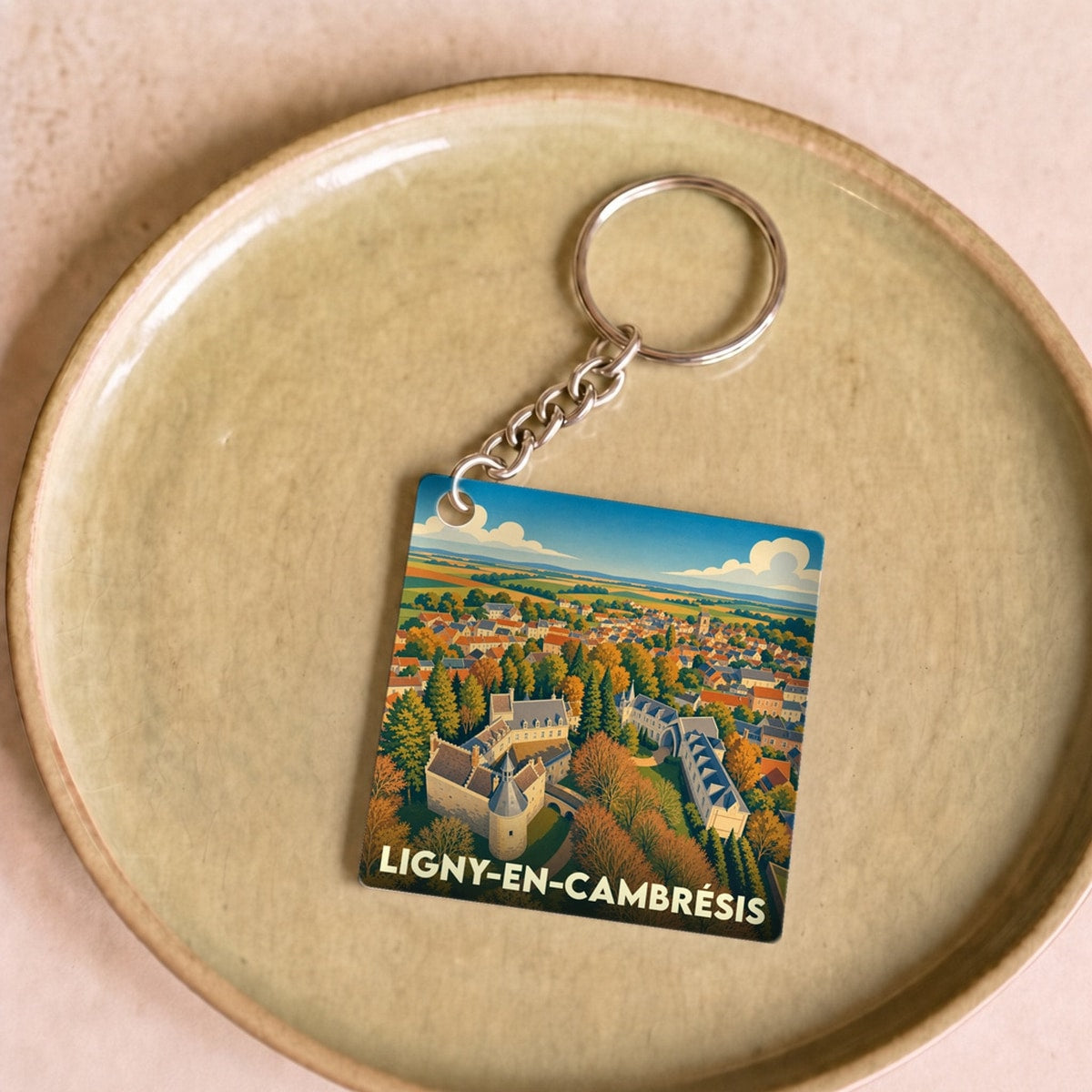 Porte-clés souvenir de la ville de Ligny-en-Cambrésis avec une illustration stylisée.