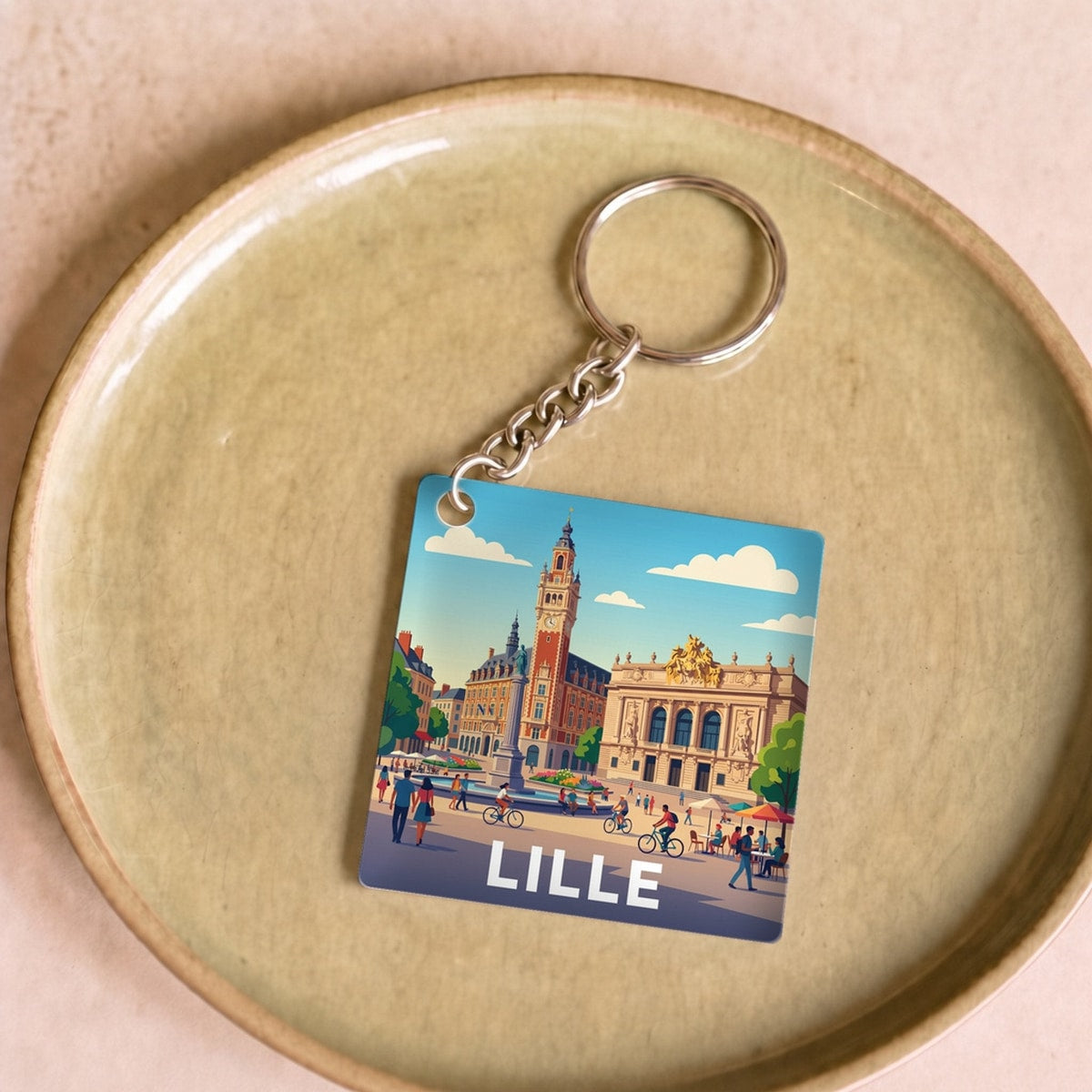Porte-clés souvenir de la ville de Lille avec une illustration stylisée.