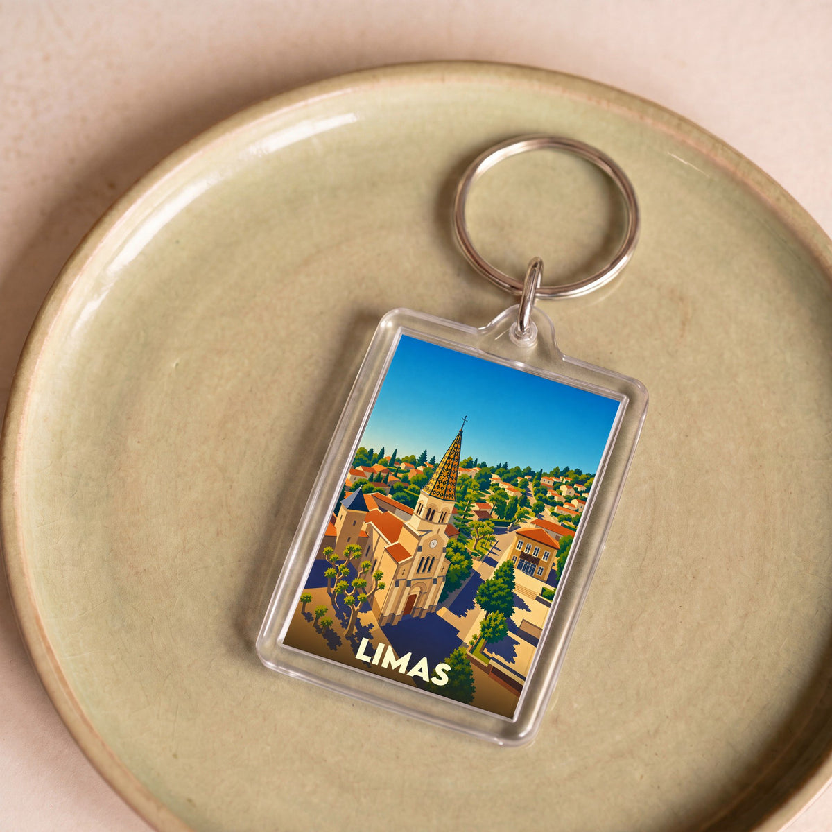 Porte-clés souvenir de la ville de Limas avec une illustration stylisée.
