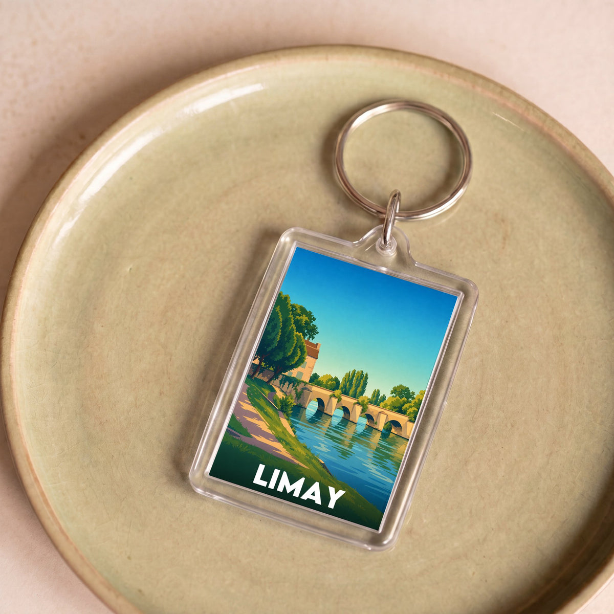 Porte-clés souvenir de la ville de Limay avec une illustration stylisée d'un pont historique.