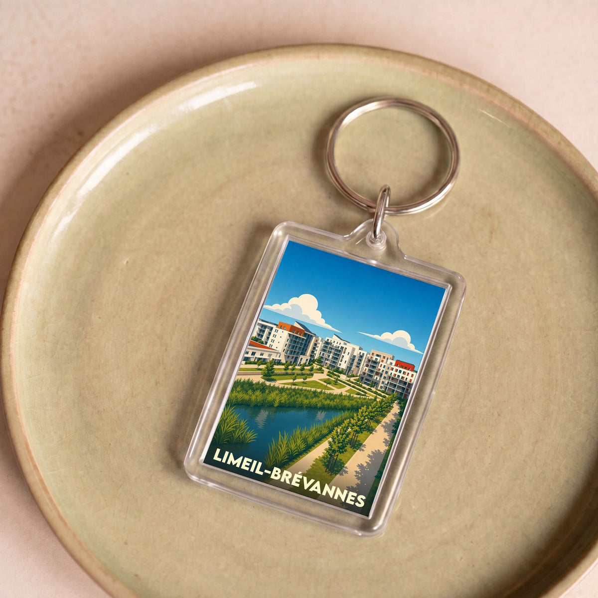 Porte-clés souvenir de la ville de Limeil-Brévannes avec une illustration stylisée d'un quartier moderne et verdoyant.