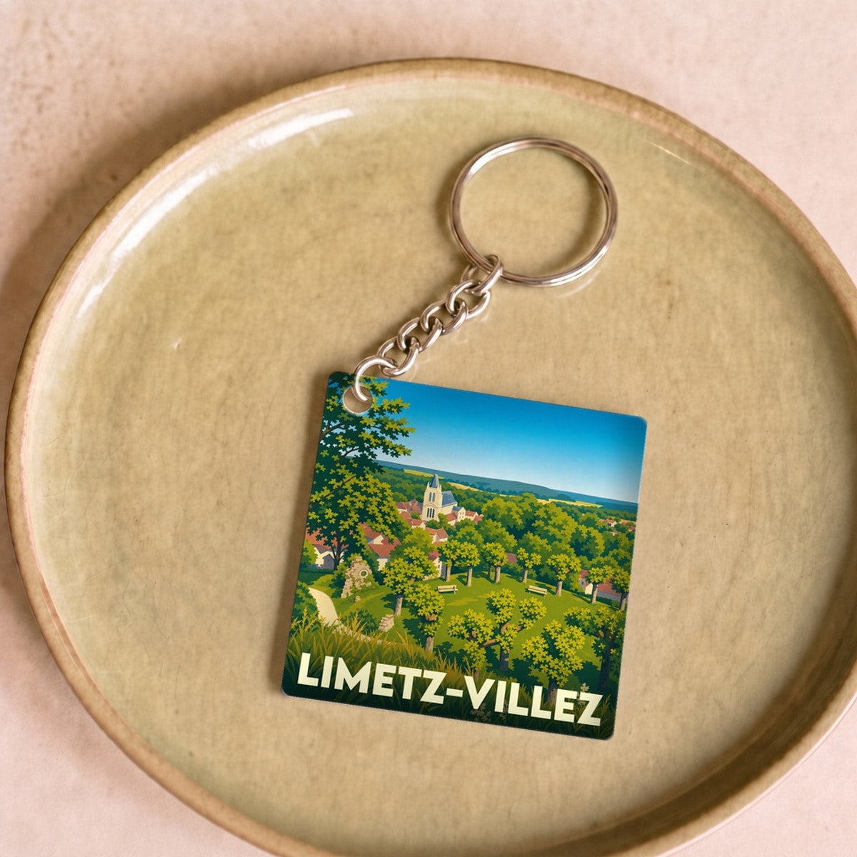 Porte-clés souvenir de la ville de Limetz-Villez avec une illustration paysagère stylisée.