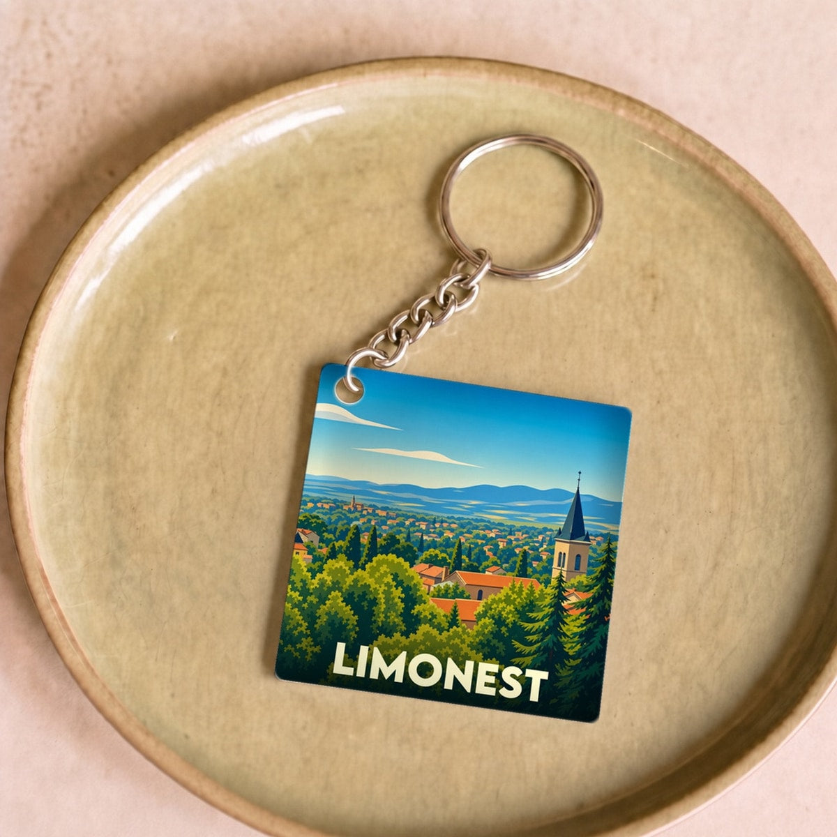 Porte-clés souvenir de la ville de Limonest avec une illustration stylisée.
