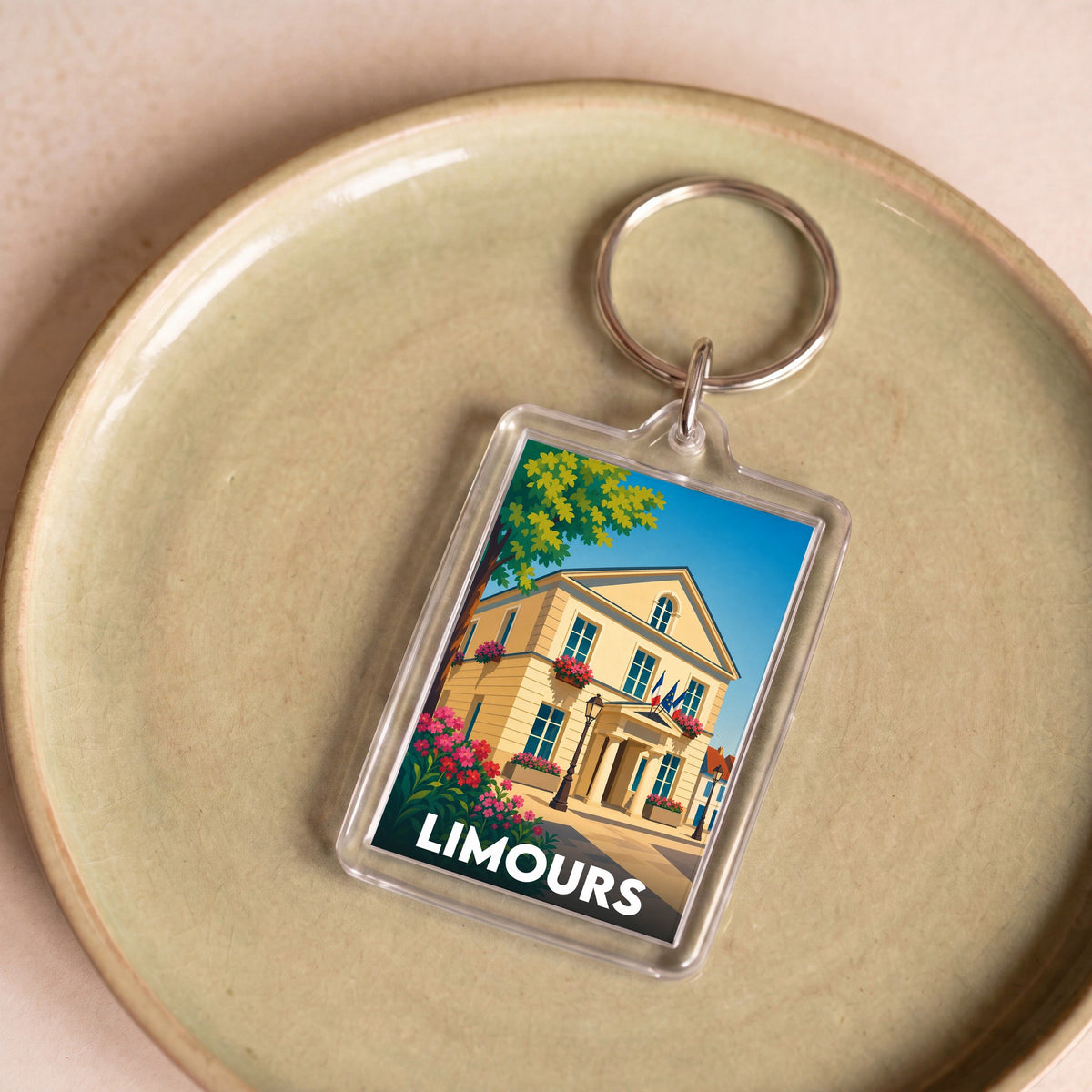 Porte-clés souvenir de la ville de Limours avec une illustration stylisée de son hôtel de ville.