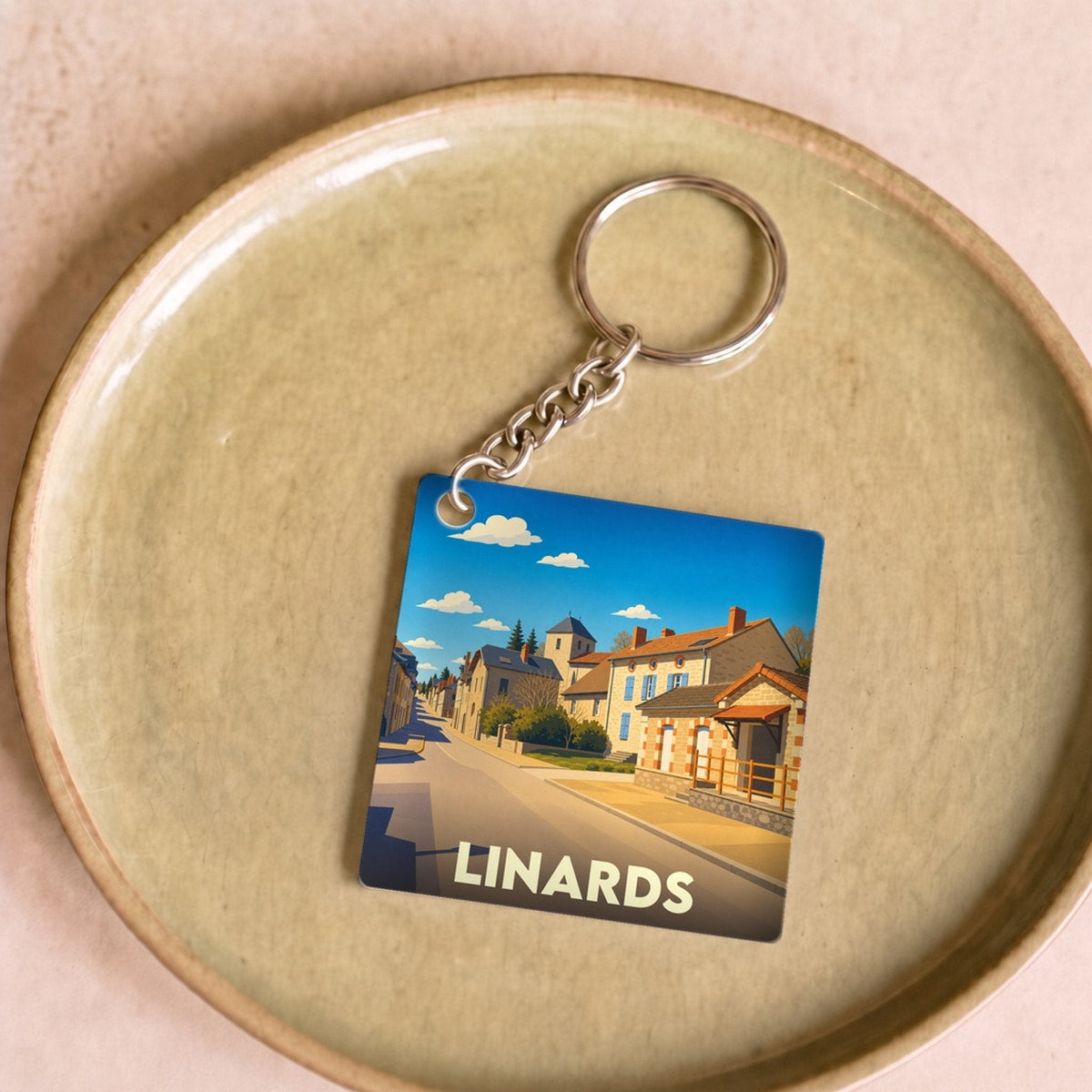 Porte-clés souvenir de la ville de Linards avec une illustration stylisée.