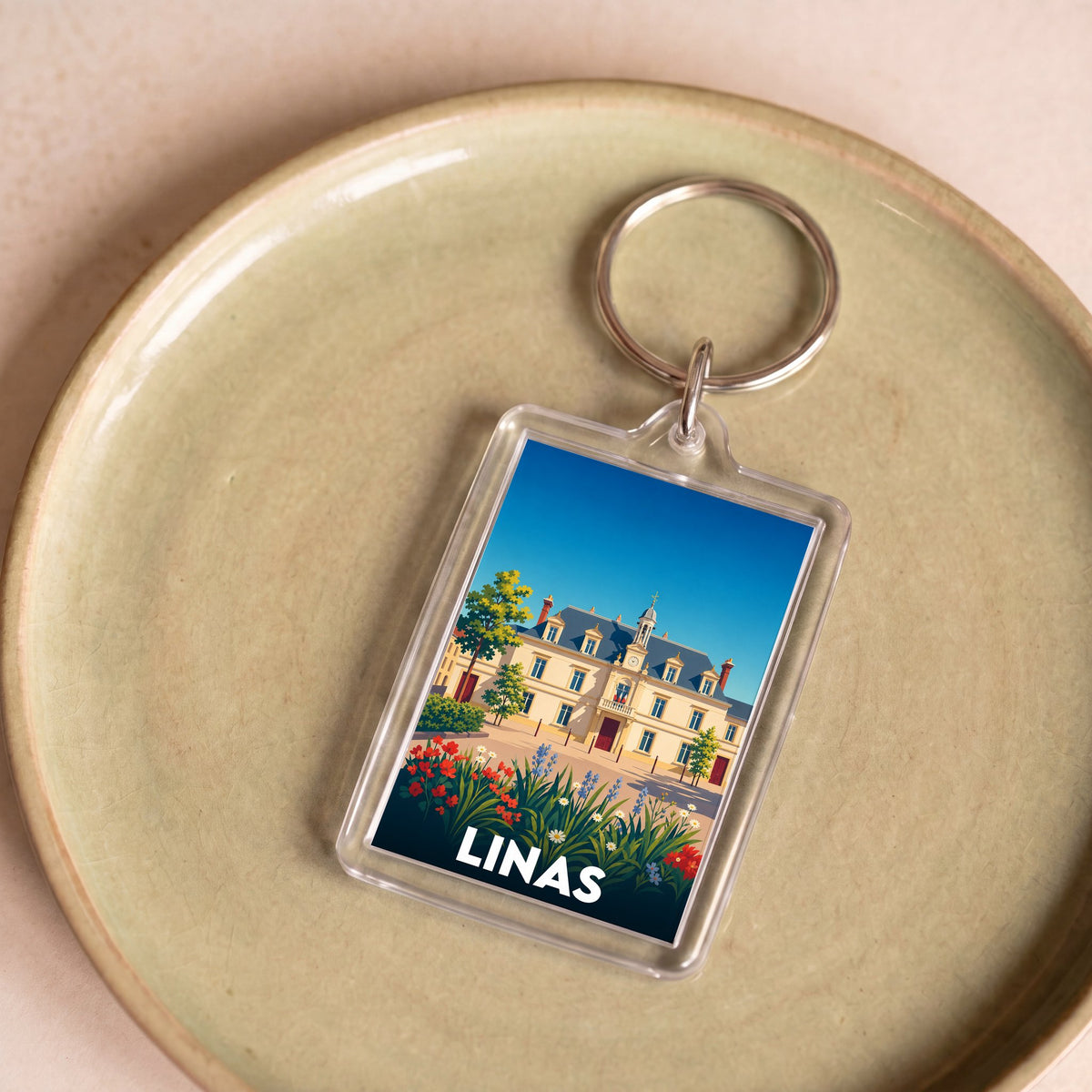 Porte-clés souvenir de la ville de Linas avec une illustration stylisée.
