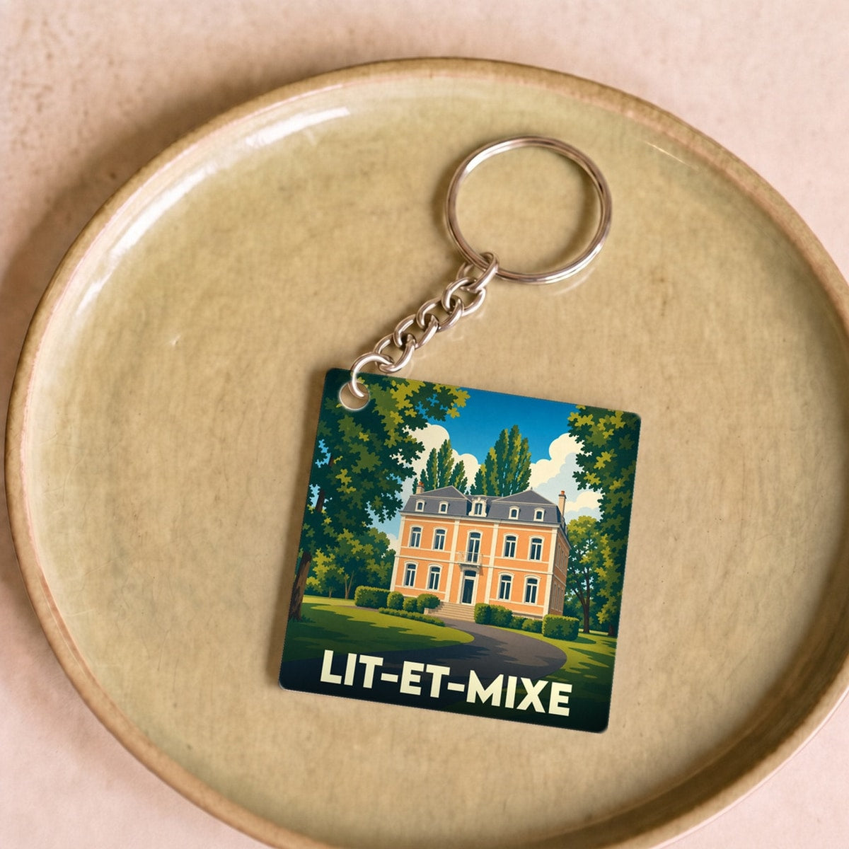 Porte-clés souvenir de la ville de Lit-et-Mixe avec une illustration stylisée.