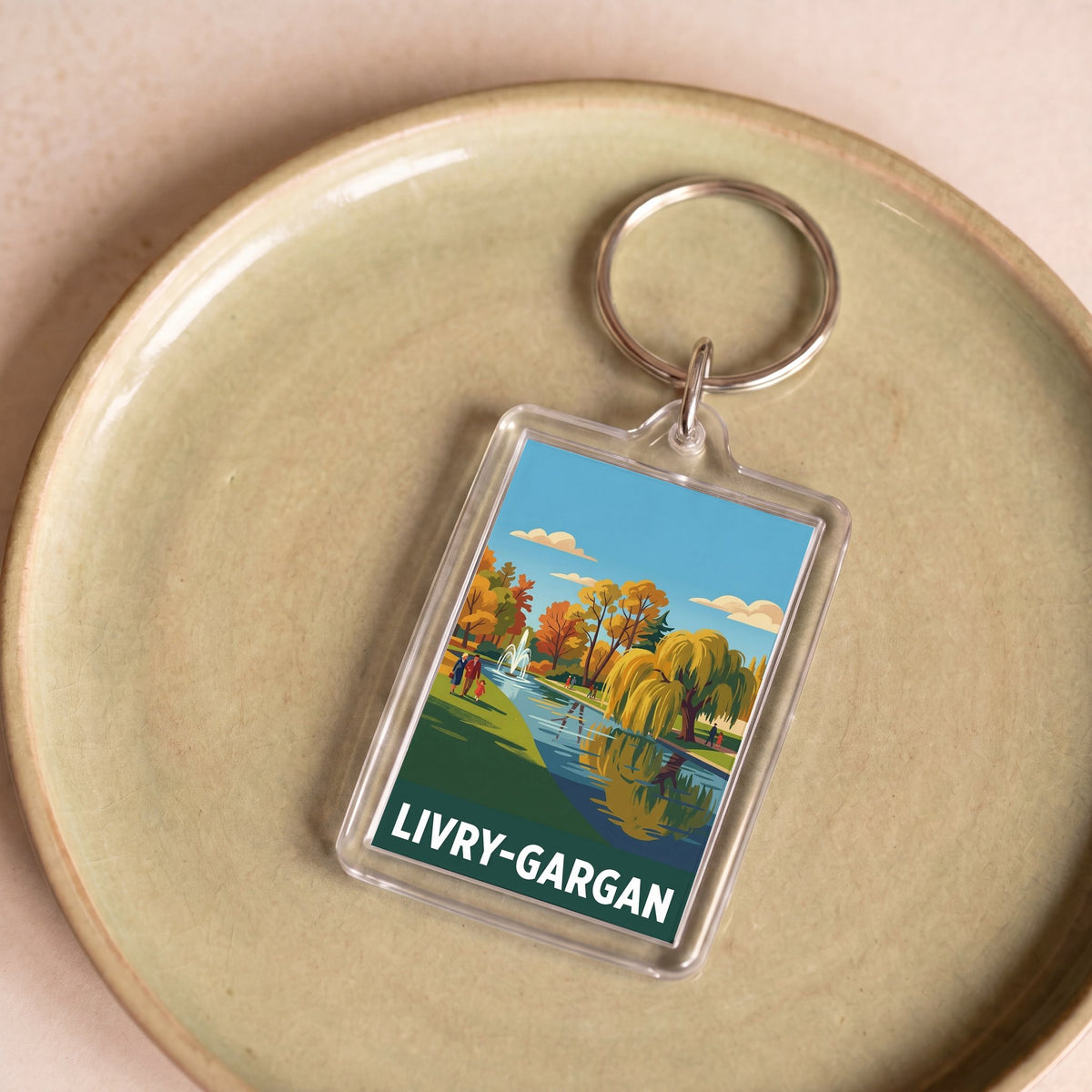 Porte-clés souvenir de la ville de Livry-Gargan avec une illustration de parc stylisée.