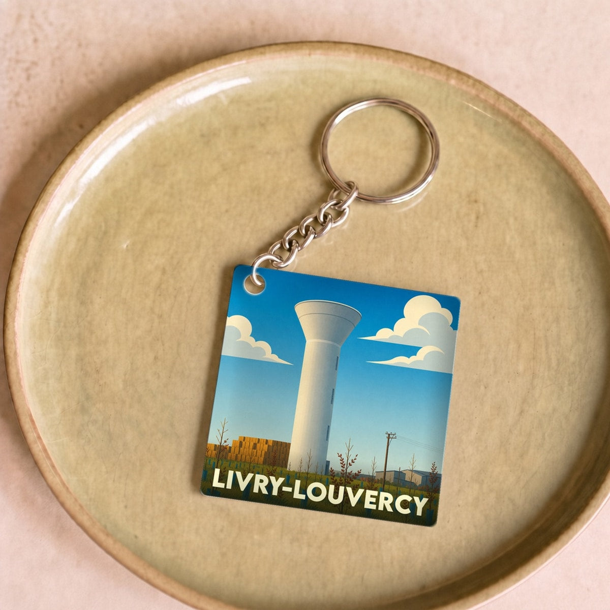 Porte-clés souvenir de la ville de Livry-Louvercy avec une illustration stylisée de son château d'eau.