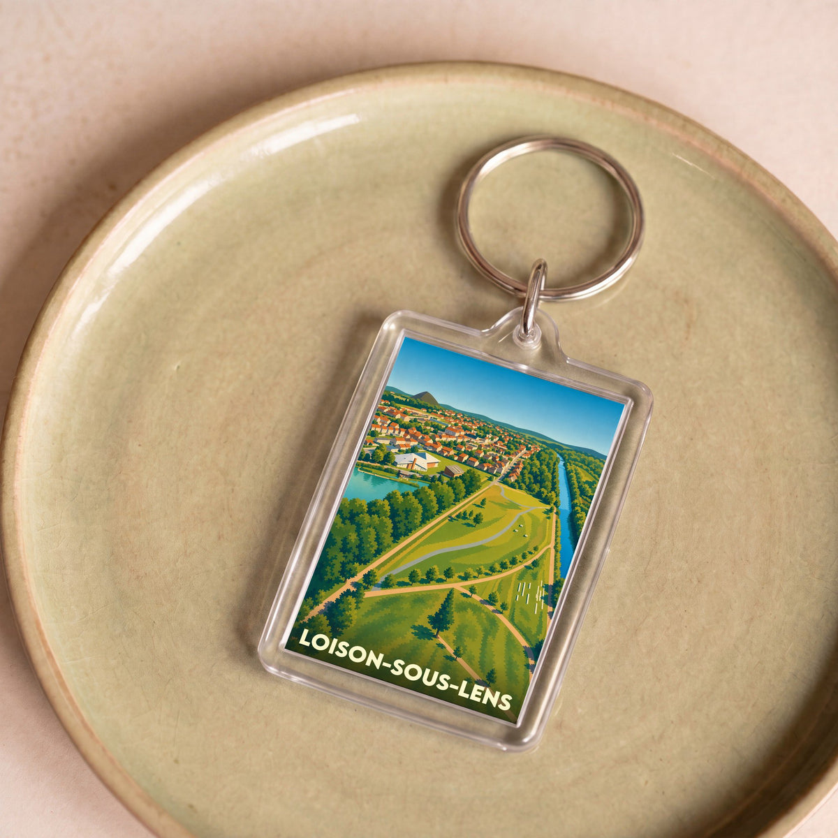 Porte-clés souvenir de la ville de Loison-sous-Lens avec une illustration paysagère stylisée.