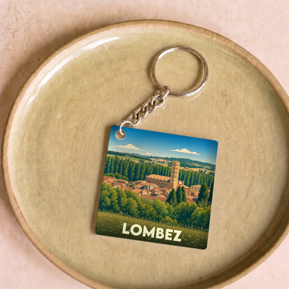 Porte-clés souvenir de la ville de Lombez avec une illustration stylisée.