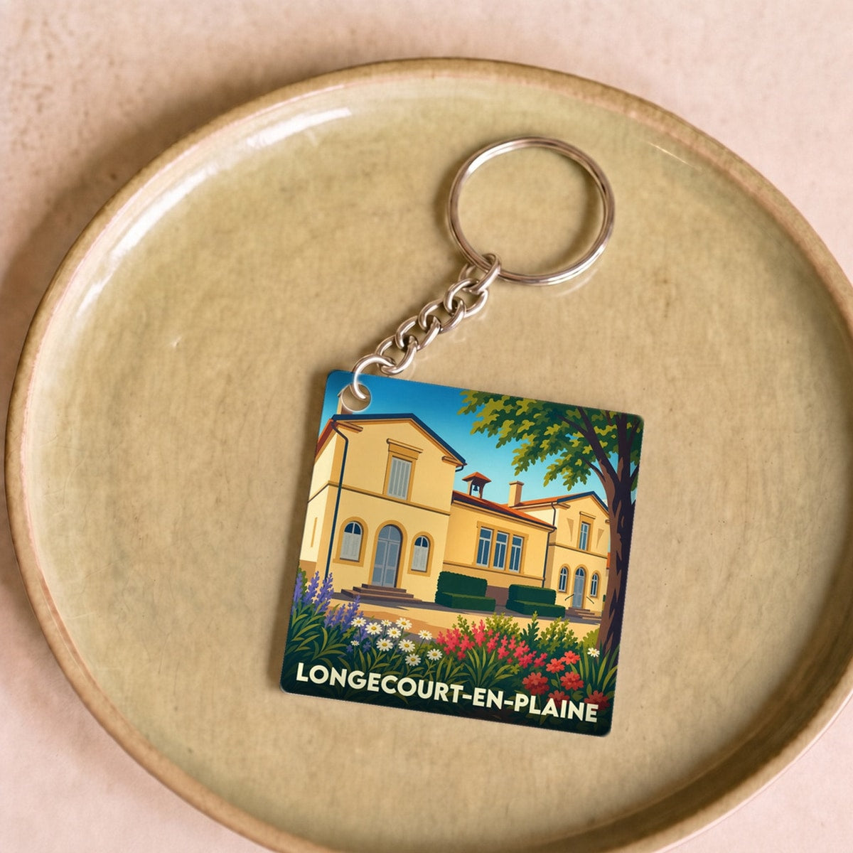 Porte-clés souvenir de la ville de Longecourt-en-Plaine avec une illustration stylisée.