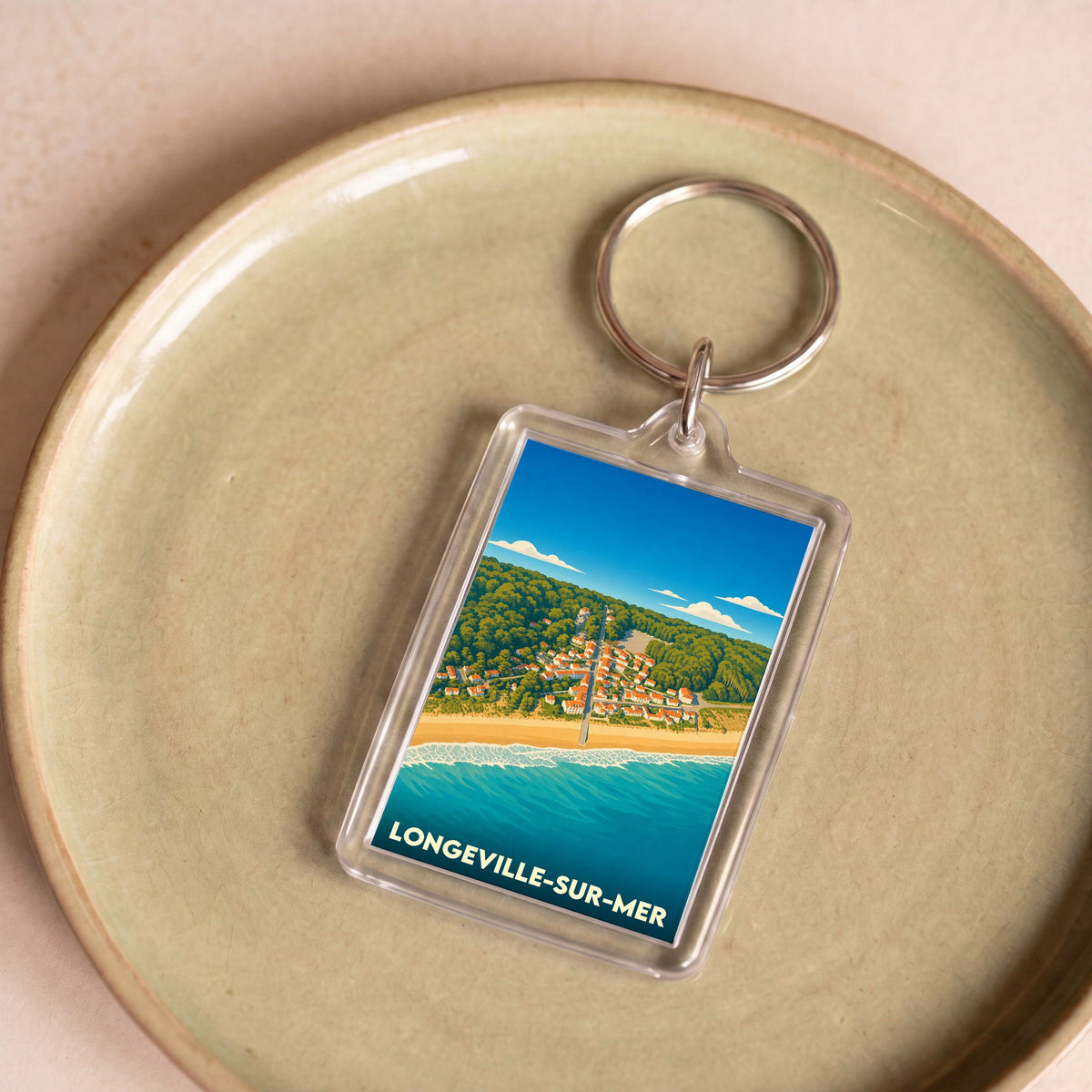 Porte-clés souvenir de Longeville-sur-Mer avec une illustration stylisée du bord de mer et du village.