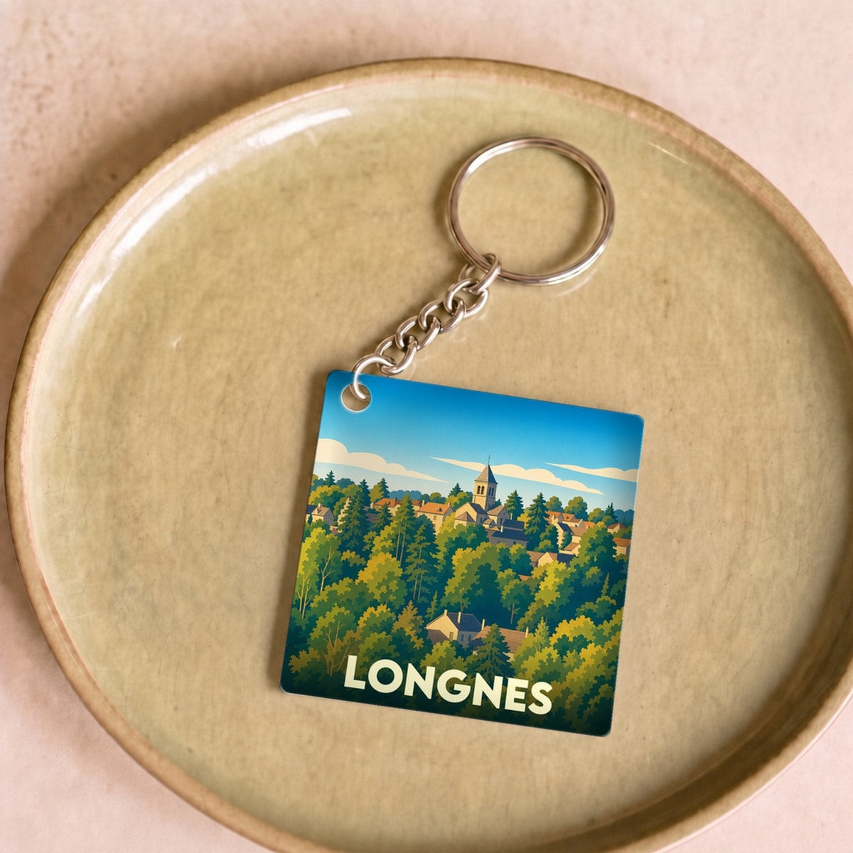 Porte-clés souvenir de la ville de Longnes avec une illustration stylisée.