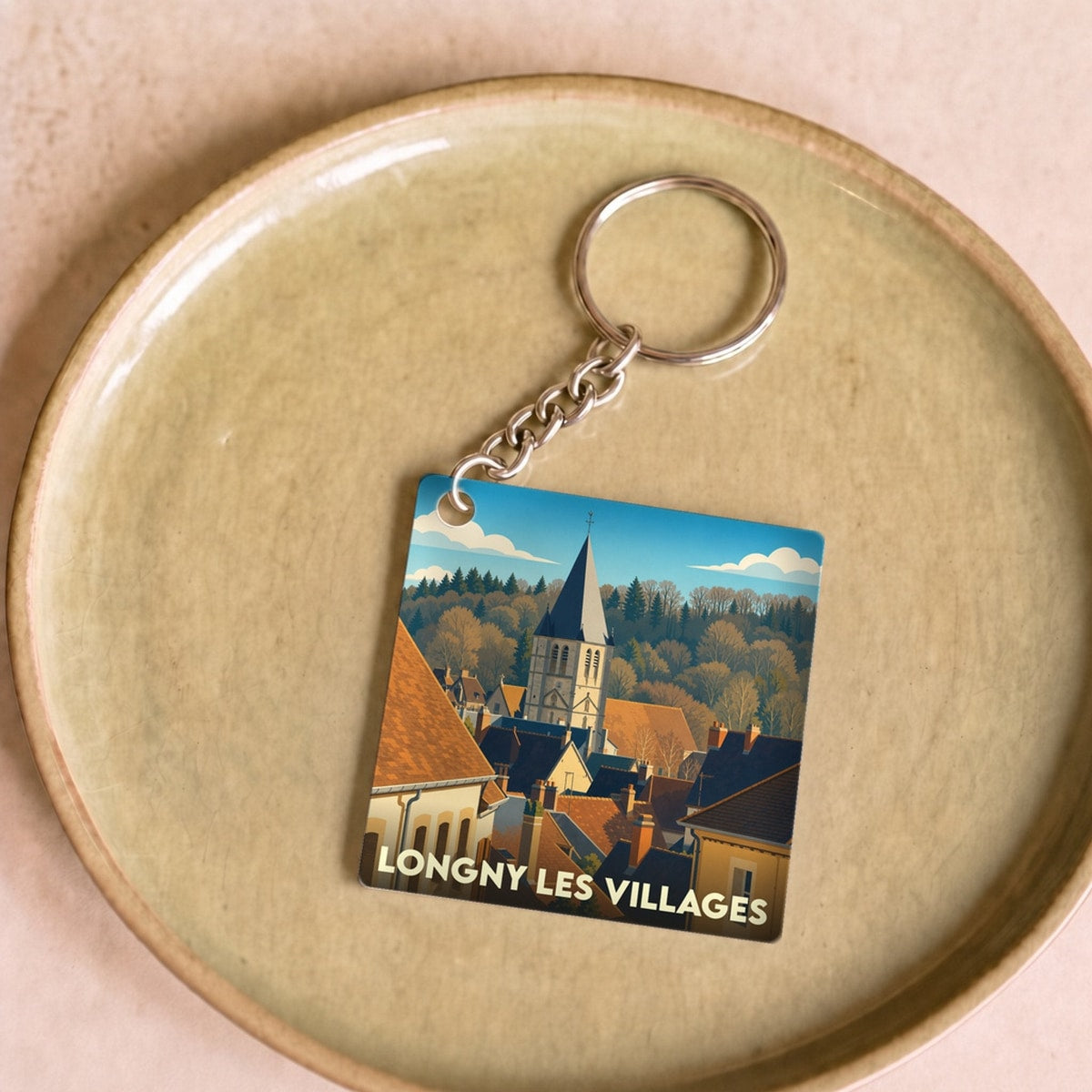 Porte-clés souvenir de la ville de Longny les Villages avec une illustration stylisée.