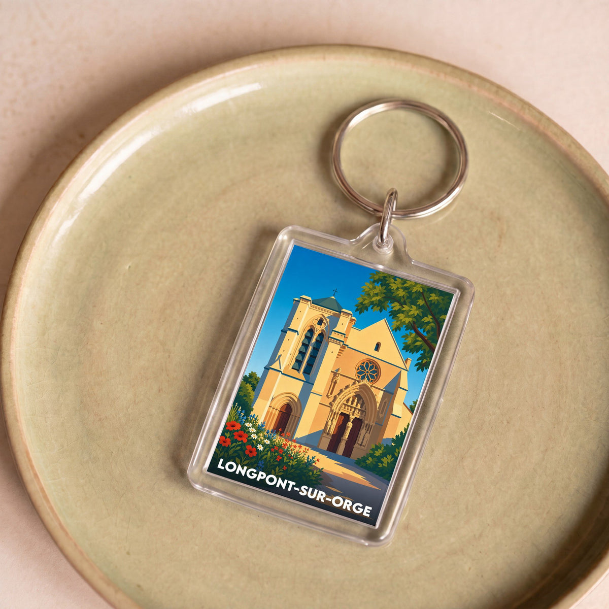 Porte-clés souvenir de la ville de Longpont-sur-Orge avec une illustration stylisée de sa basilique.