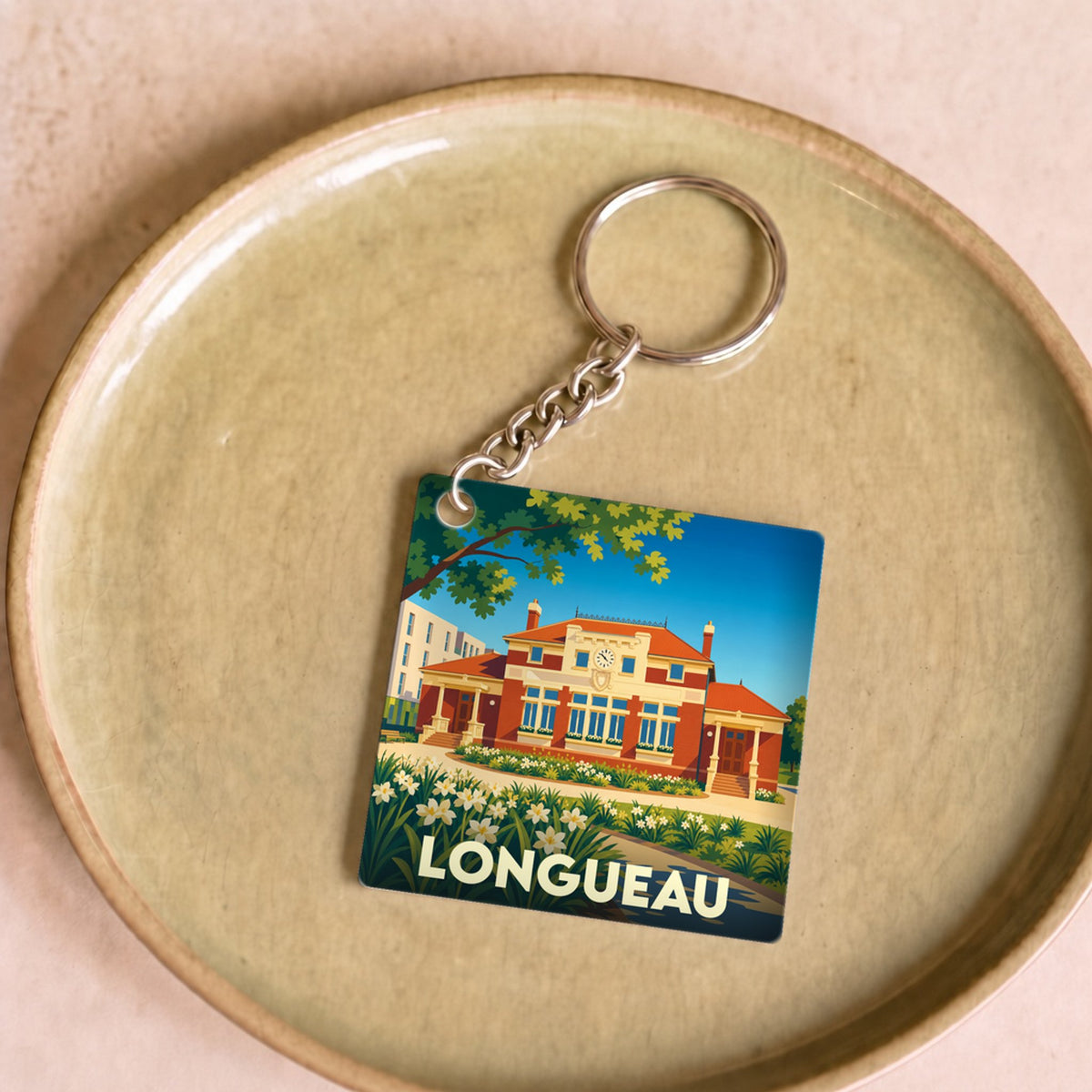 Porte-clés souvenir de la ville de Longueau avec une illustration stylisée.