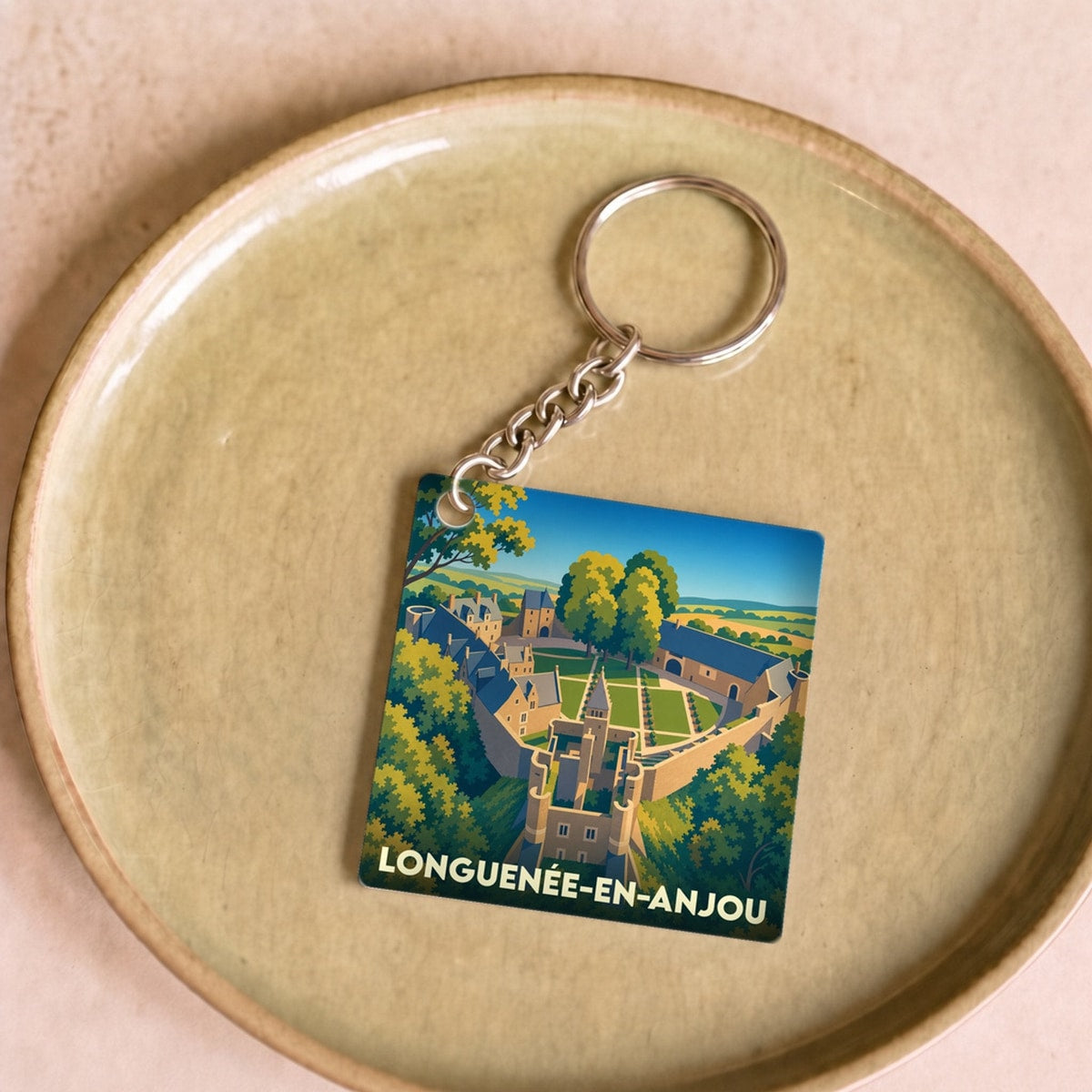 Porte-clés souvenir de la ville de Longuenée-en-Anjou avec une illustration stylisée.
