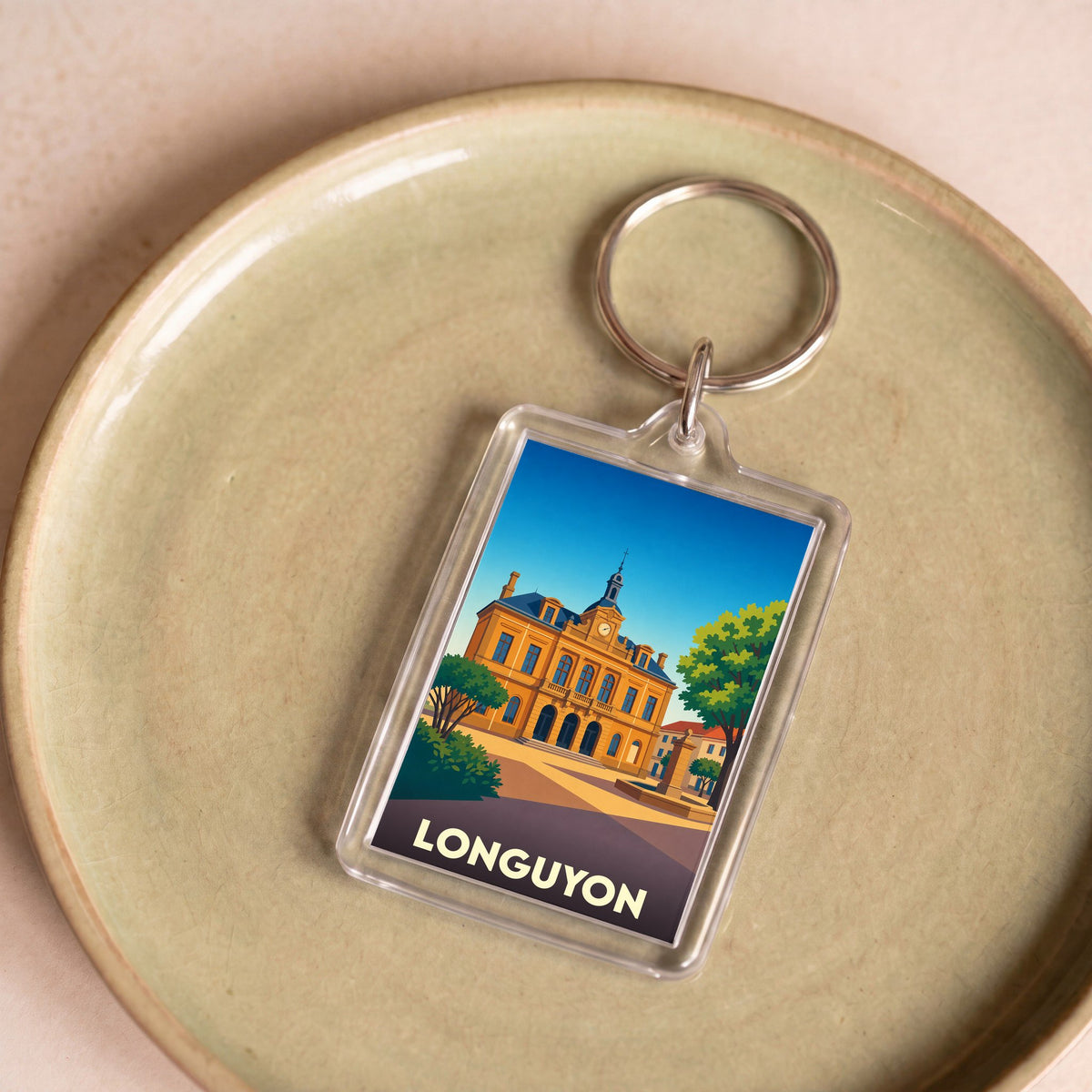 Porte-clés souvenir de la ville de Longuyon avec une illustration stylisée de son hôtel de ville.