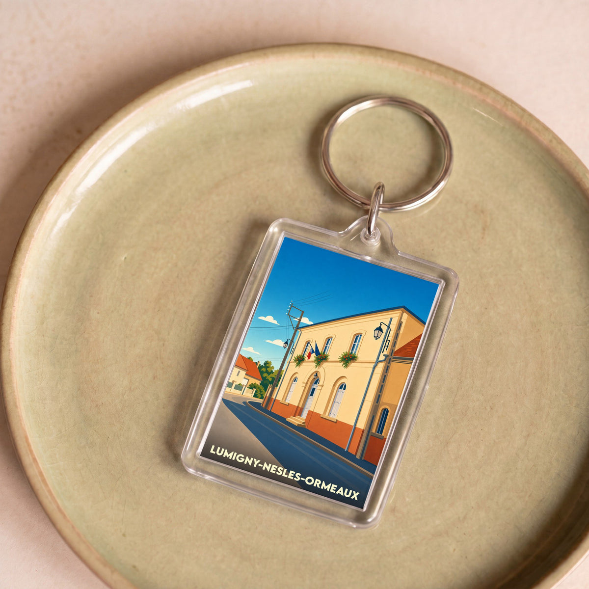 Porte-clés souvenir de la ville de Lumigny-Nesles-Ormeaux avec une illustration stylisée.