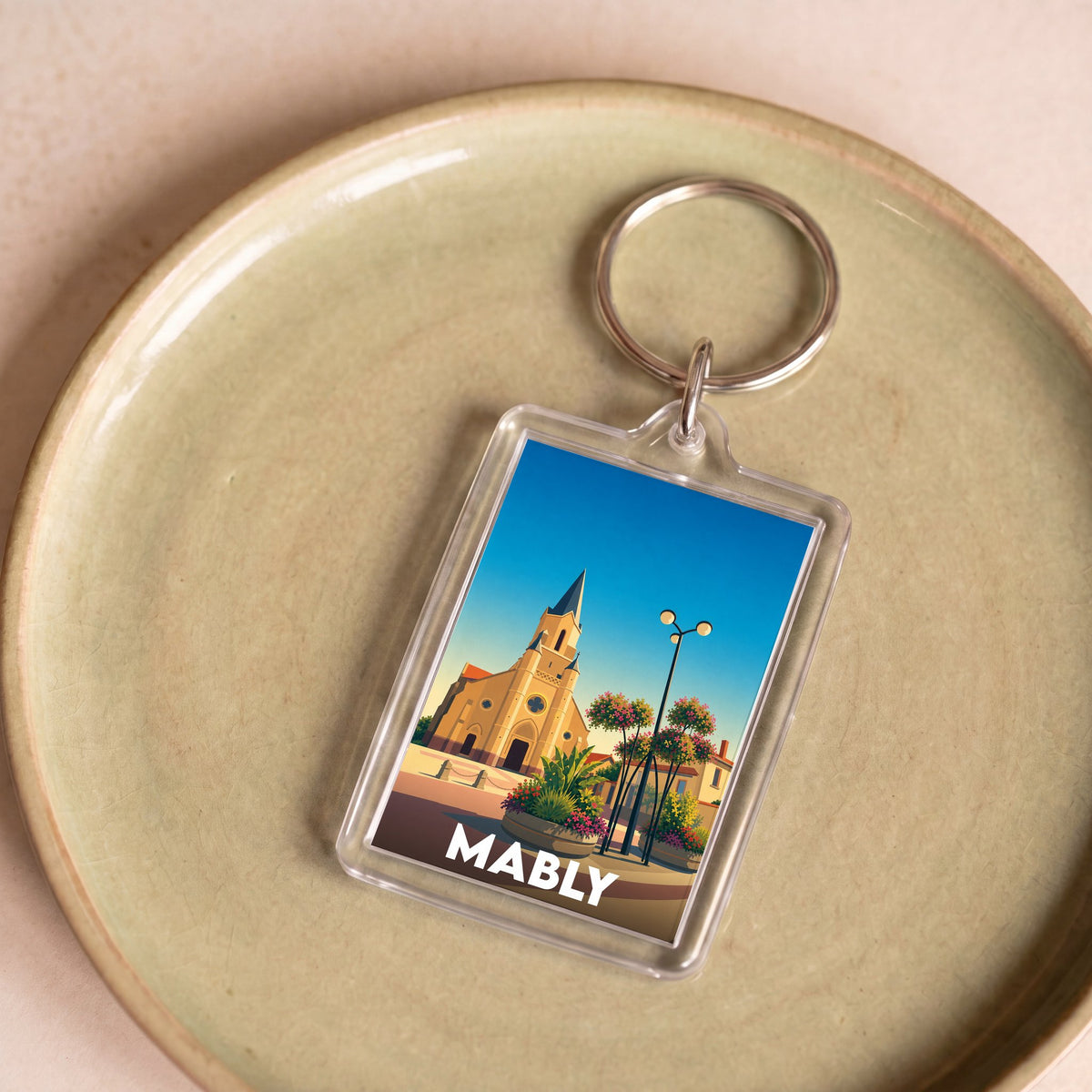 Porte-clés souvenir de la ville de Mably avec une illustration stylisée.