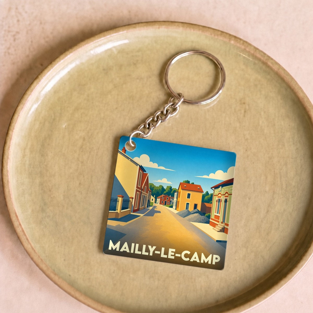 Porte-clés souvenir de la ville de Mailly-le-Camp avec une illustration stylisée.