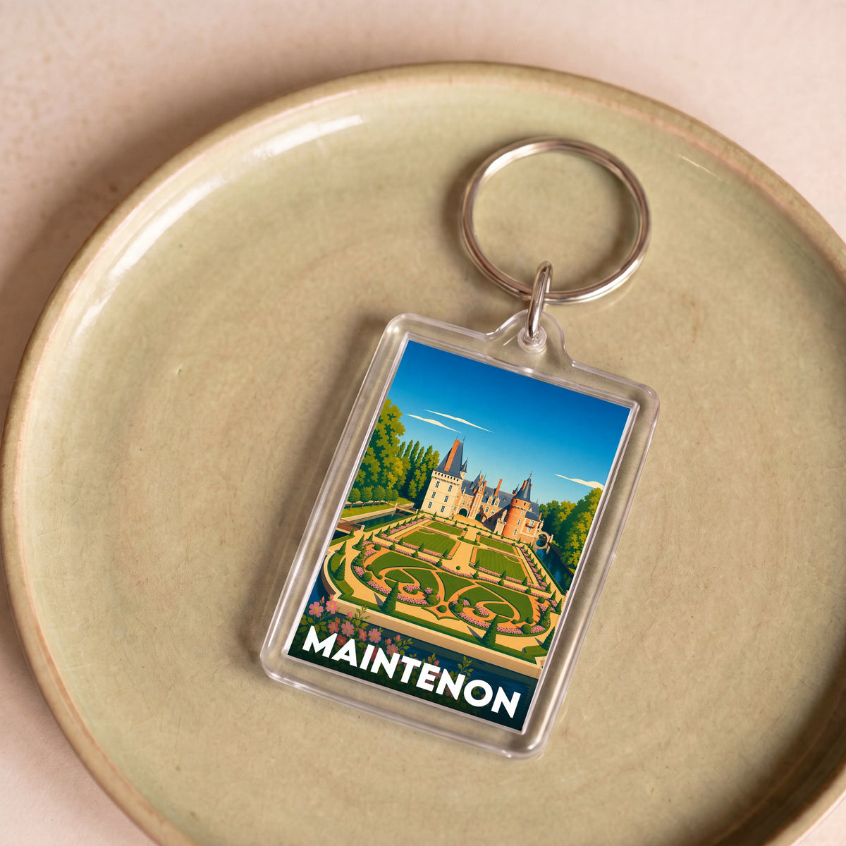 Porte-clés souvenir de la ville de Maintenon avec une illustration stylisée de son château.