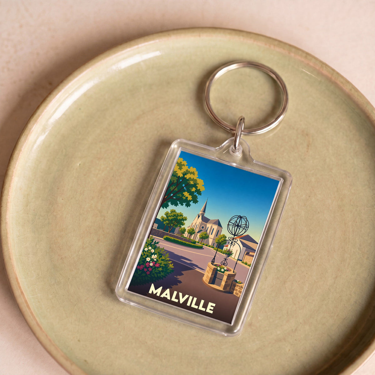 Porte-clés souvenir de la ville de Malville avec une illustration stylisée.