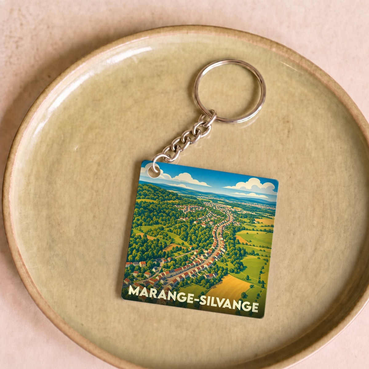 Porte-clés souvenir de la ville de Marange-Silvange avec une illustration stylisée.