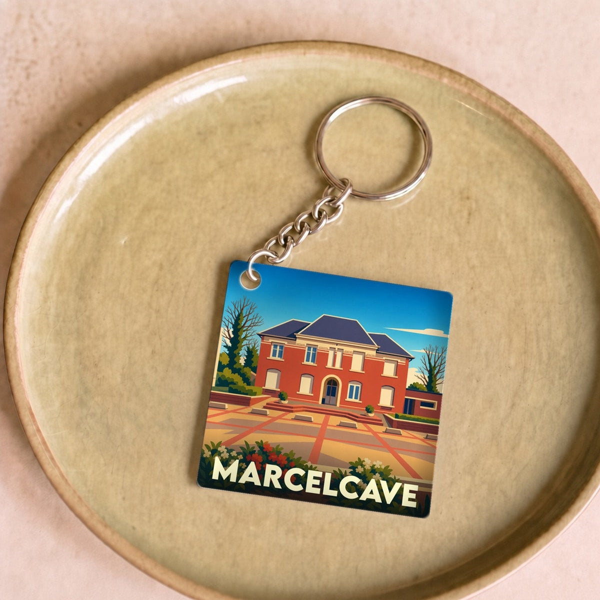 Porte-clés souvenir de la ville de Marcelcave avec une illustration stylisée de sa mairie.
