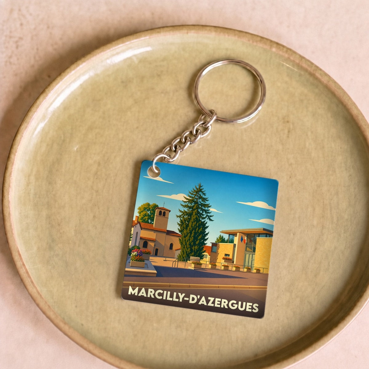 Porte-clés souvenir de la ville de Marcilly-d'Azergues avec une illustration stylisée.