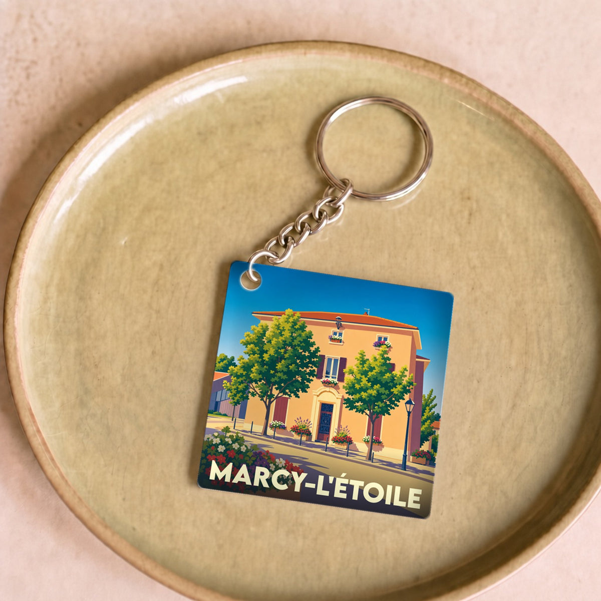 Porte-clés souvenir de la ville de Marcy-l'Étoile avec une illustration stylisée.