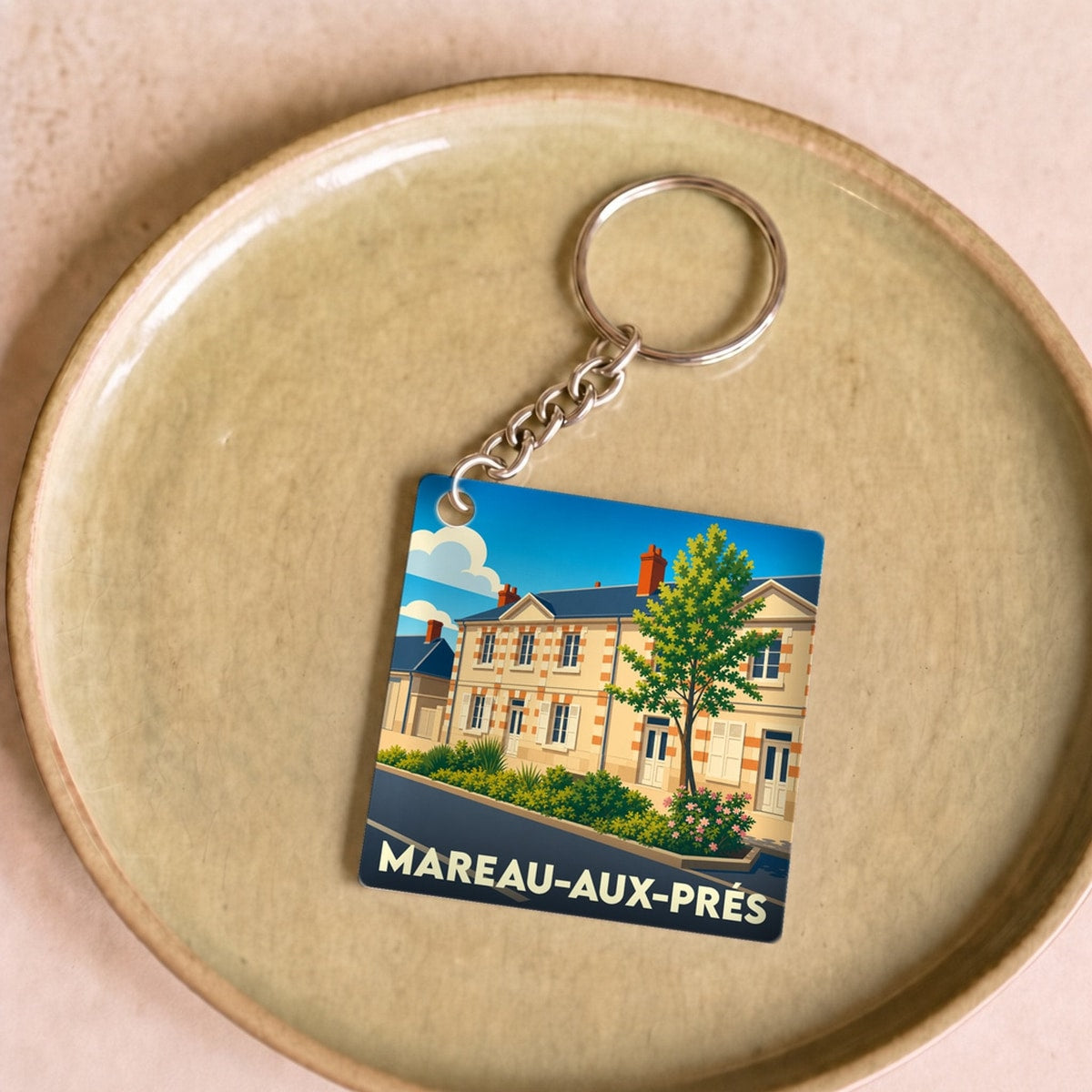 Porte-clés souvenir de la ville de Mareau-aux-Prés avec une illustration stylisée.