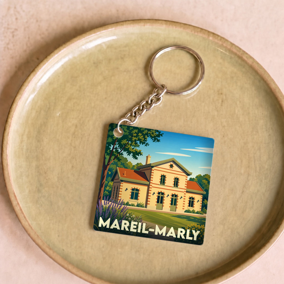 Porte-clés souvenir de la ville de Mareil-Marly avec une illustration stylisée de sa gare.