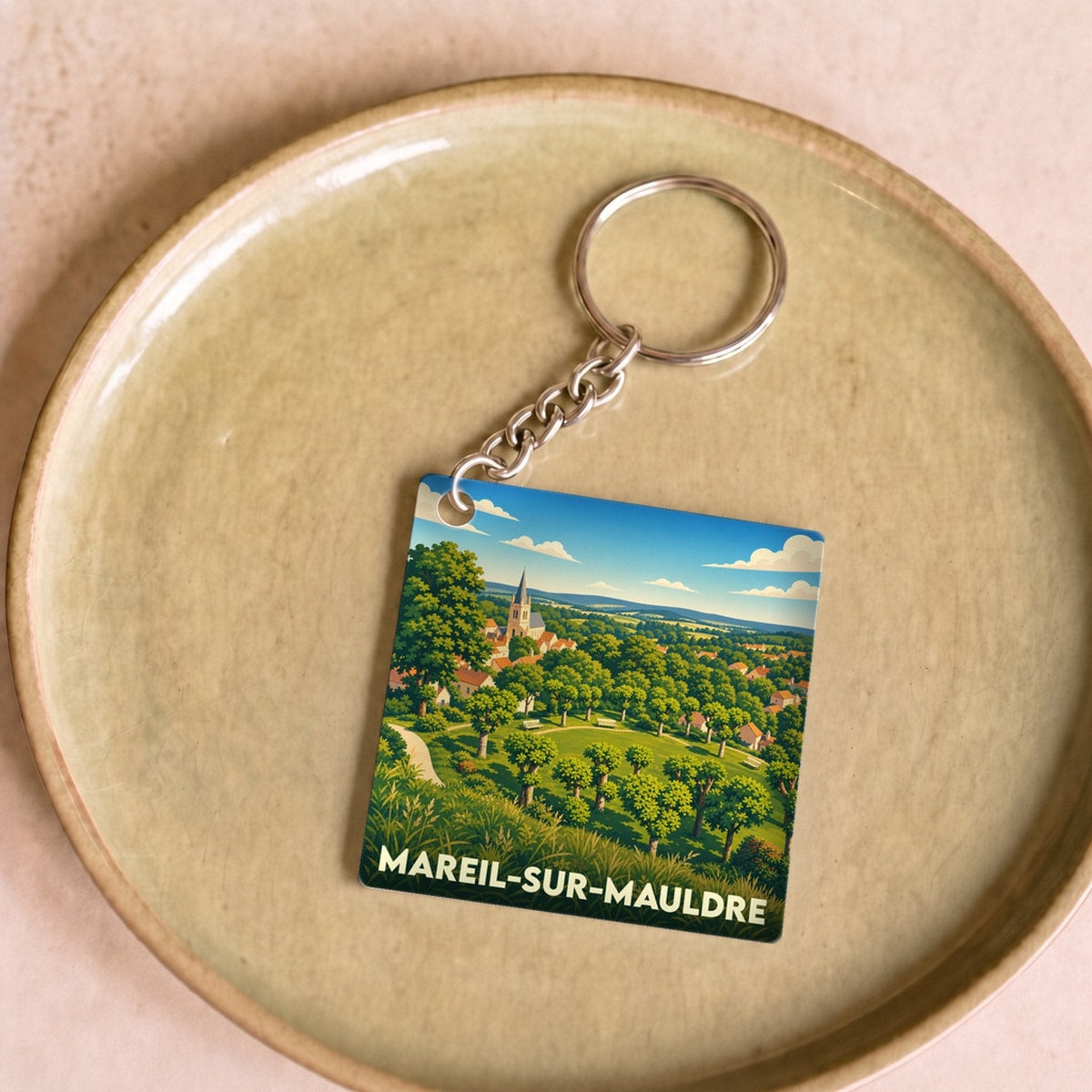 Porte-clés souvenir de la ville de Mareil-sur-Mauldre avec une illustration stylisée.